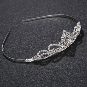 Elegant silver rhinestone crown headband for brides and girls on a black textured background
