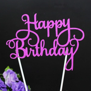 Pink glitter Happy Birthday cake topper with two white sticks on black background