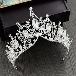Detailed close-up of a silver baroque crown with shimmering rhinestones and crystals