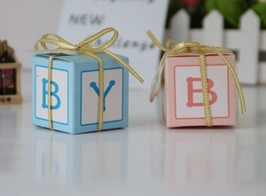 Detail of pink and blue DIY letter chocolate boxes with golden edge ribbons for parties