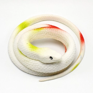 Top view of realistic TPR cobra toy with green and orange spots on white body