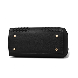 Bottom view of black leather handbag featuring gold metal feet and woven craft details