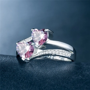 Detail view of double heart-shaped pink zircon stones on silver-plated copper band