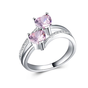 Detailed view of dual pink heart-shaped crystals with micro-paved silver-plated band