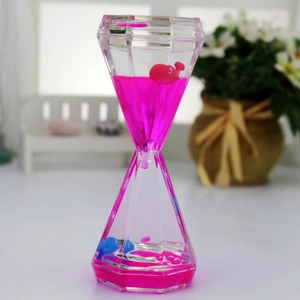 Detail of diamond-shaped liquid motion bubbler with floating pink whale and blue fish