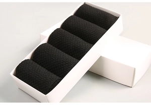 Set of five black bamboo fiber socks neatly rolled in a premium white gift drawer box