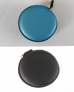 Close-up of circular EVA storage cases in blue and black with durable metal zippers