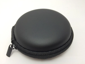 Close-up of matte black round EVA storage case with a durable metal zipper closure