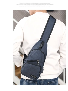 Navy blue crossbody chest bag with USB port shown on a person for actual wear effect