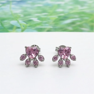 Detail of pink crystal cat paw earrings with rose gold plating and zircon heart