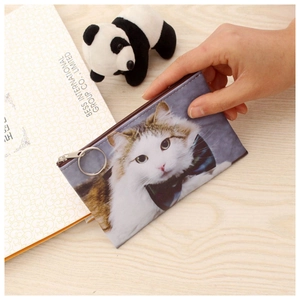Detailed view of gray cat coin purse featuring blue bowtie print and large ring zipper pull