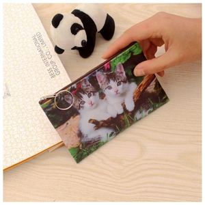 Close-up of a white canvas cat coin purse featuring a zipper and metal key ring loop