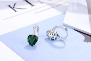 Detail of S925 silver heart-shaped emerald green zircon earrings with micro-pave setting