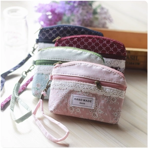 Detailed view of floral pattern coin purses with lace trim and zipper handles