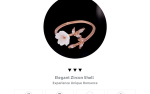 Detail of rose gold open ring with carved white shell flower and marquise zirconia