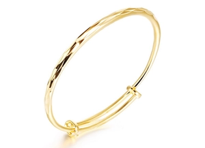 Close-up of 18K gold plated adjustable bangle featuring geometric textured facets
