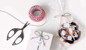 Detail of red and black bicolor 3-strand cotton rope rolls for DIY gift wrapping