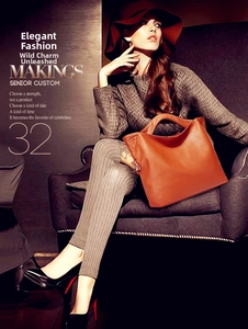 Detailed view of brown lychee grain leather tote bag with wing trapezoid structure