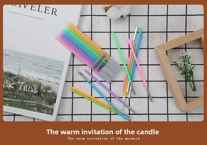 Detail showing long gradient rainbow candles in clear packaging for birthday cake decor
