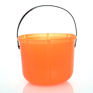 Classic orange pumpkin candy bucket with black wire handle for Halloween decorations