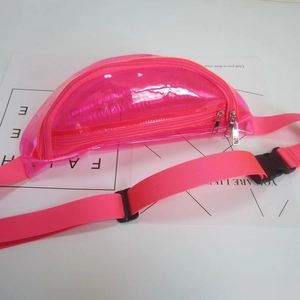 Detailed view of a bright pink transparent PVC waist bag with adjustable strap.