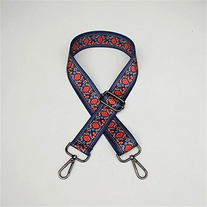 Detail of ethnic embroidery bag strap with vintage floral patterns and gunmetal hardware