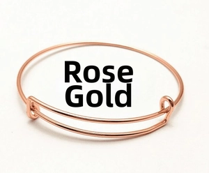 Detailed view of adjustable rose gold wire bangle with sliding mechanism on white background