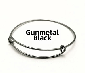 Detailed close-up of a gunmetal black adjustable wire bangle with polished finish