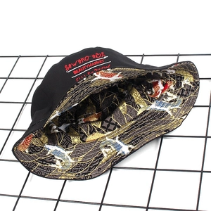 Reversible bucket hat featuring black embroidery and Japanese koi fish print design