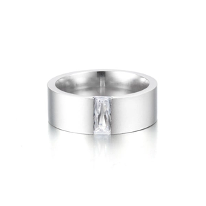 Polished silver wide band ring with a rectangular clear zircon stone on white background