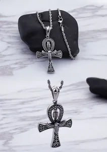 Macro view of stainless steel Ankh pendant with Egyptian scarab and wing engravings