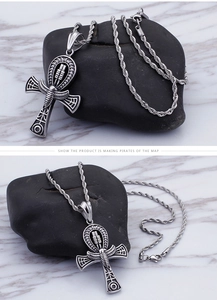 Detailed close-up of a silver stainless steel Ankh cross pendant with intricate engravings