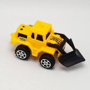 Detail view of the yellow toy bulldozer with movable front shovel and rugged black wheels