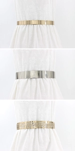 Close-up of three metal belts featuring mirror finish and hollow floral patterns