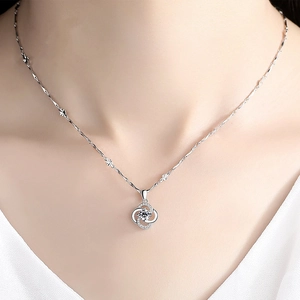 Elegant 925 silver plated four-leaf clover pendant necklace with rotating crystal on a model