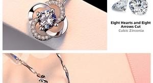 Detail of silver clover pendant with heart and arrow cut cubic zirconia stone