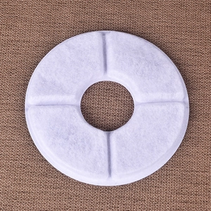 Close-up of a round white replacement filter for pet water fountains with four sections
