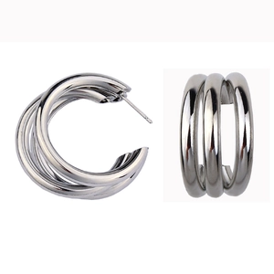 Macro view of silver triple-hoop C-shaped earrings with a high-polished metallic finish