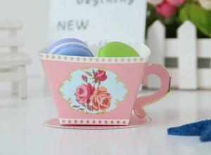 Pink paper tea cup candy box with rose floral patterns and matching saucer for tea party decor