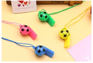 Close-up of colorful soccer ball shaped plastic whistles with matching lanyards