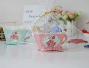 Detail of European floral tea cup shaped paper gift boxes in pink and teal colors