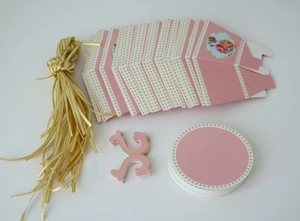Flat lay of pink DIY paper gift box set with gold ribbons and floral decorative stickers