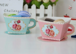 Detail of vintage floral gift boxes in teacup shape with mint green and pink finish
