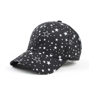 Detailed close-up of a black baseball cap featuring white star prints and cotton twill texture