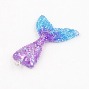 Detailed view of resin mermaid tail pendant with blue-purple gradient and glitter finish