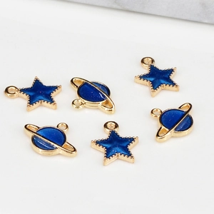 Detail of star and planet charms with blue enamel and gold plating for DIY jewelry making