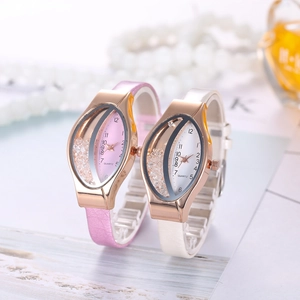 Close-up of fashionable oval quartz watches with leather straps and floating crystal dials