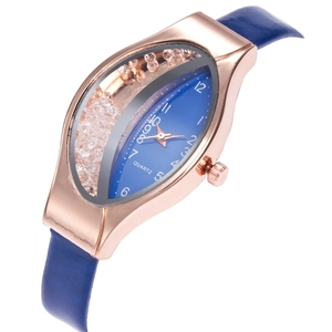 Detail of creative oval watch with rose gold case, blue dial and floating rhinestones
