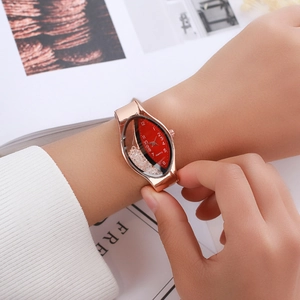 Detailed close-up of a women's rose gold oval quartz watch with floating crystals