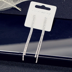 Detail of silver long tassel earrings with double-row sparkling rhinestones on white card